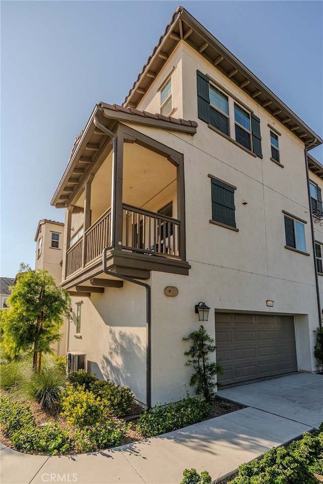 view of property featuring a garage and central air condition unit