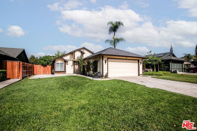 view of front of property with a front yard and a garage