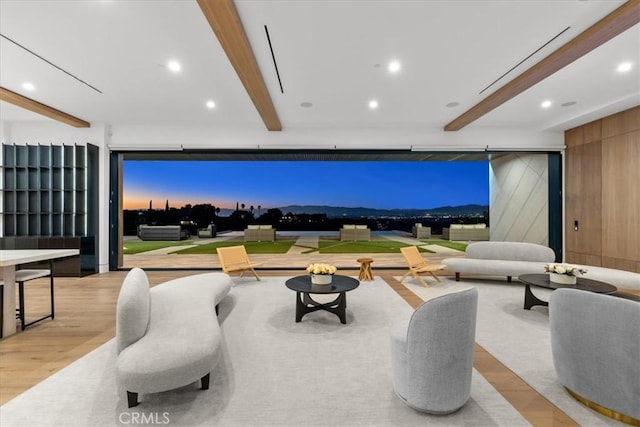 game room featuring beamed ceiling, light wood-type flooring, and wood walls