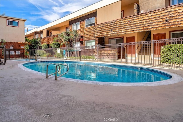 view of swimming pool featuring a patio area