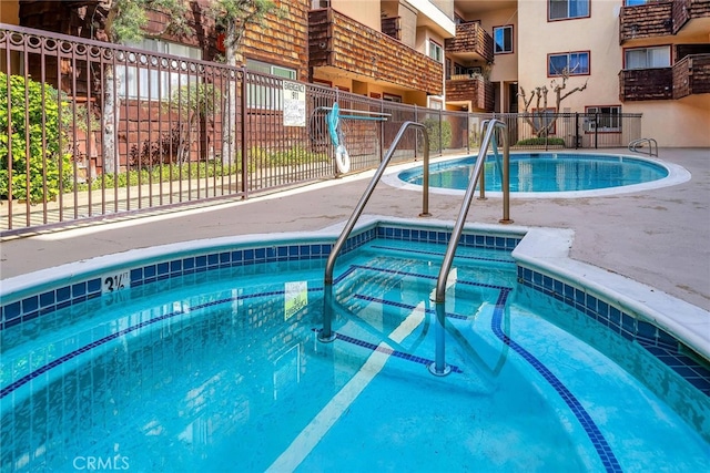 view of pool with a community hot tub