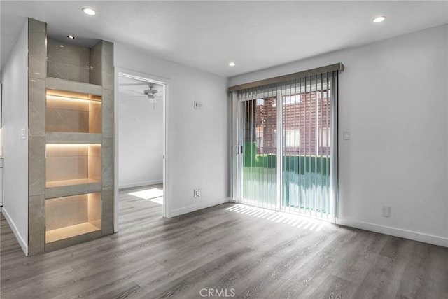 unfurnished room featuring hardwood / wood-style floors and ceiling fan