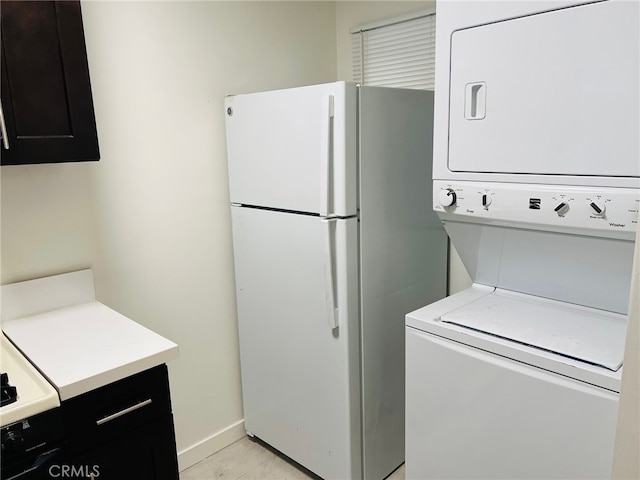 laundry area with stacked washer and dryer