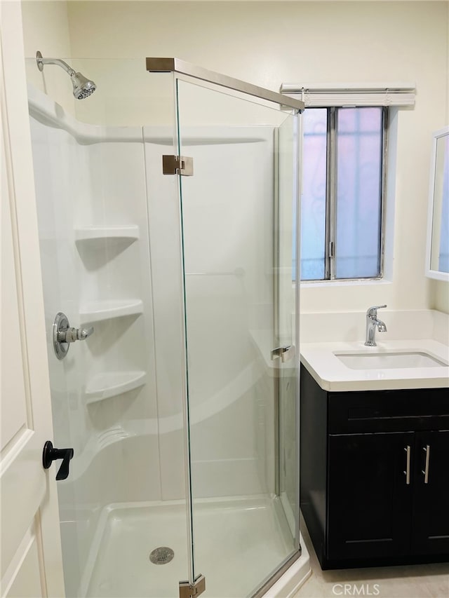 bathroom with walk in shower and vanity