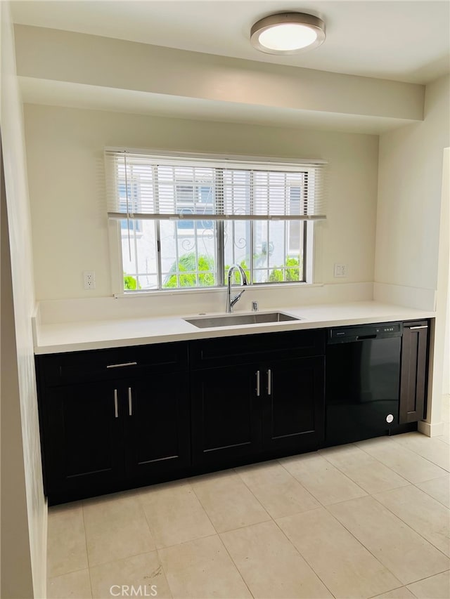 kitchen featuring dishwasher, light tile patterned floors, sink, and plenty of natural light