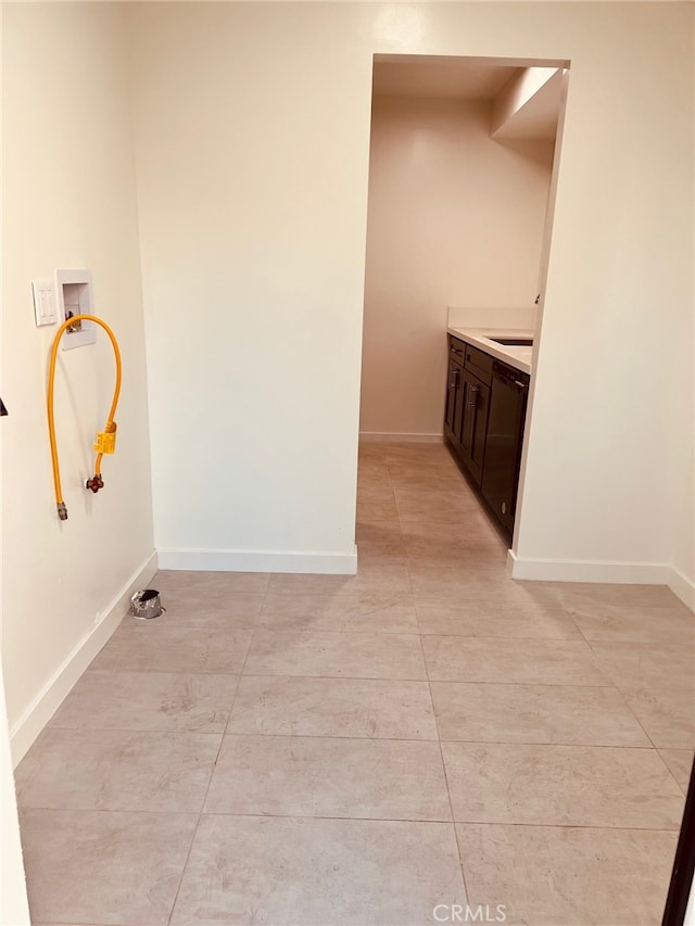 clothes washing area featuring cabinets, washer hookup, and sink