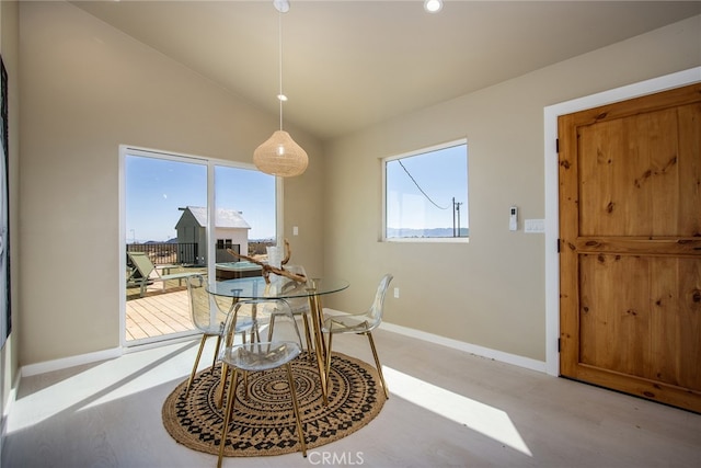 dining space with lofted ceiling and a healthy amount of sunlight