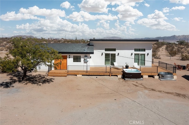 exterior space with a deck with mountain view