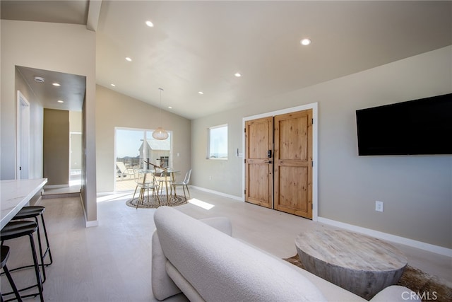 living room featuring lofted ceiling