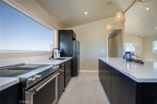 kitchen featuring appliances with stainless steel finishes, vaulted ceiling, light wood-type flooring, decorative light fixtures, and sink