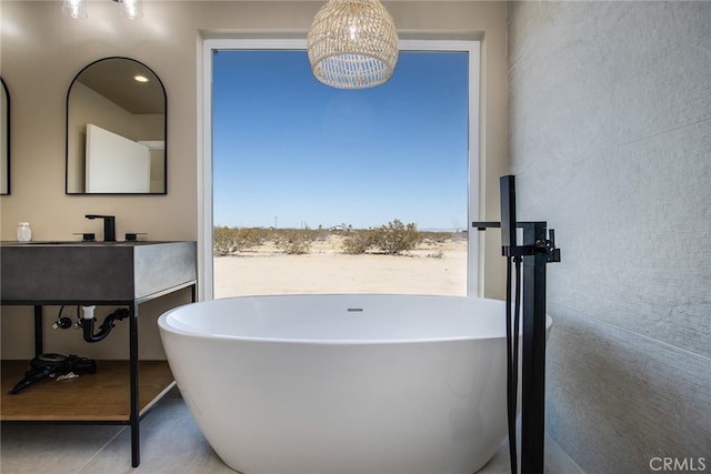 bathroom with vanity, a bathing tub, and tile patterned floors