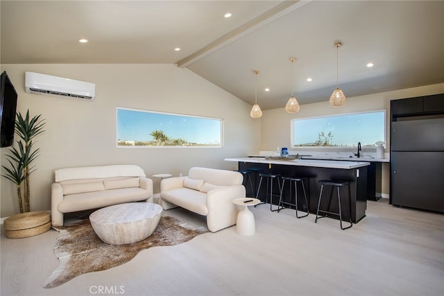 living room with lofted ceiling with beams, light wood-type flooring, sink, and a wall mounted AC