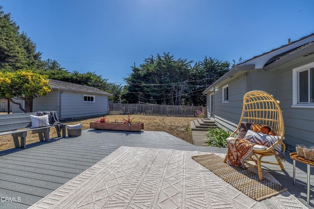 wooden terrace featuring an outdoor structure