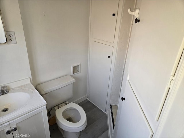 bathroom featuring hardwood / wood-style floors, vanity, and toilet