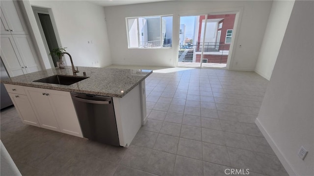 kitchen featuring a center island with sink, stainless steel dishwasher, sink, and white cabinets