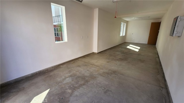 empty room featuring a healthy amount of sunlight and concrete flooring