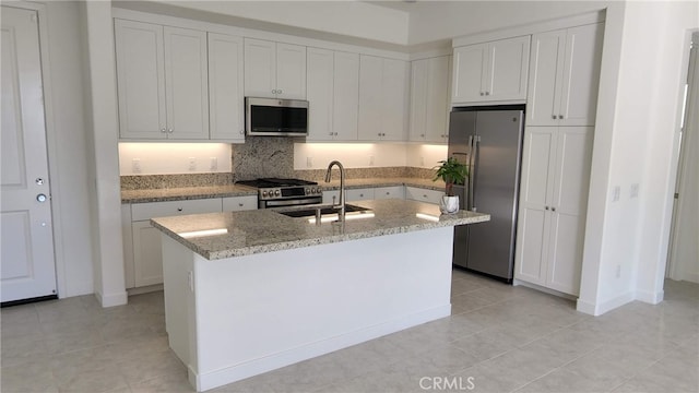 kitchen featuring an island with sink, white cabinetry, appliances with stainless steel finishes, and sink