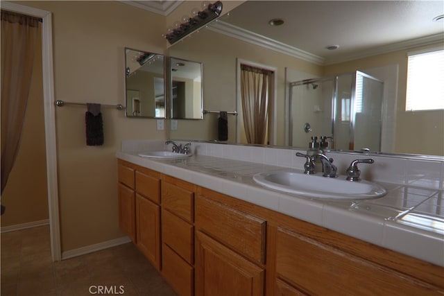 bathroom with ornamental molding, a shower with door, vanity, and tile patterned floors