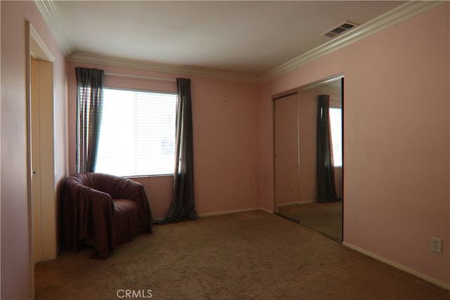 unfurnished room with ornamental molding and carpet floors