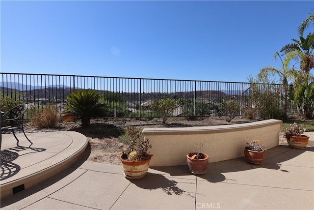 view of patio / terrace featuring a mountain view