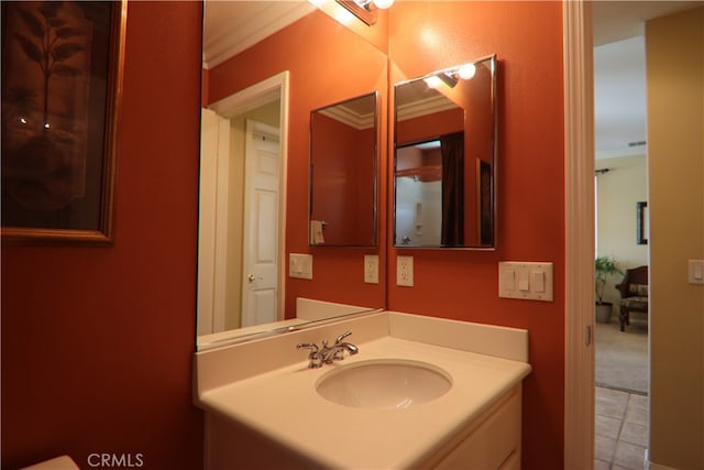 bathroom with ornamental molding and vanity