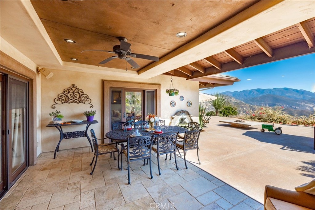 view of patio featuring a mountain view and ceiling fan