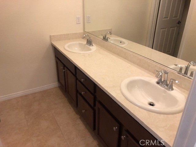 bathroom featuring tile patterned flooring and vanity