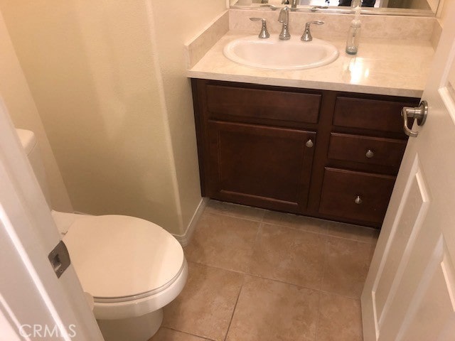 bathroom with tile patterned floors, vanity, and toilet