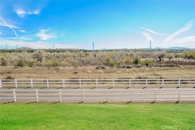 view of yard featuring a rural view and fence