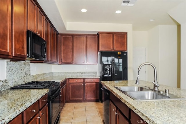 kitchen featuring a sink, black appliances, visible vents, and dark brown cabinets