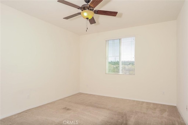 empty room with a ceiling fan and light colored carpet