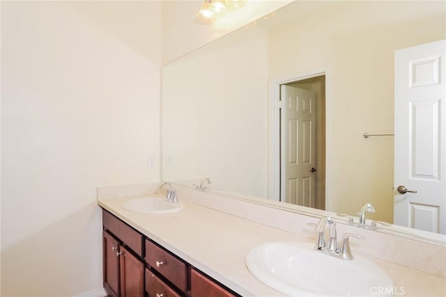 full bath with double vanity and a sink