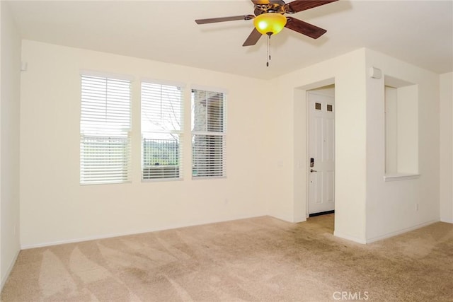 unfurnished room featuring a ceiling fan and light colored carpet