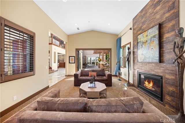 living room with a large fireplace and lofted ceiling