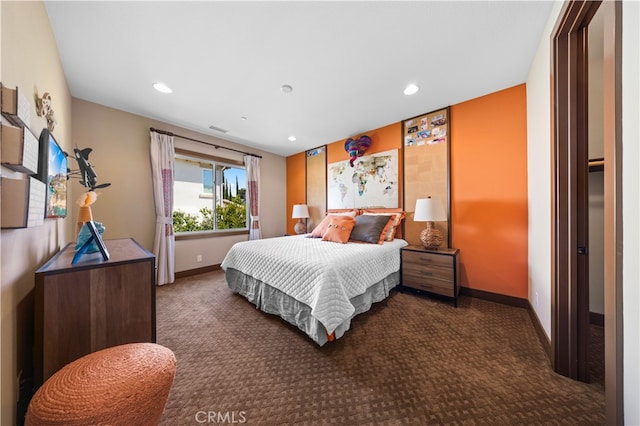 bedroom with dark colored carpet