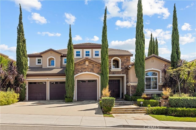 mediterranean / spanish-style house with a garage