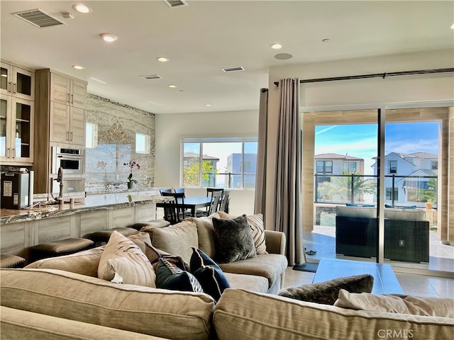 living room with light tile patterned flooring and sink