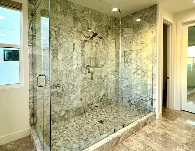 bathroom featuring a shower with shower door