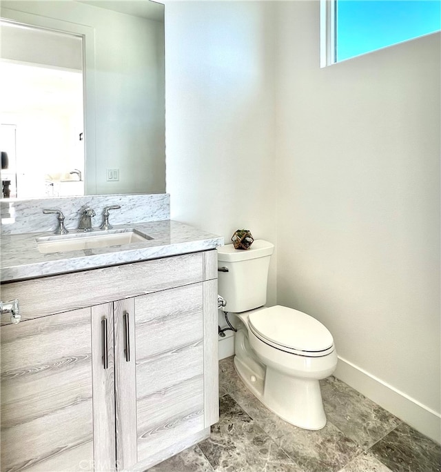 bathroom featuring toilet and vanity