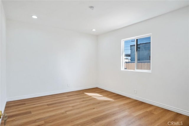 unfurnished room with light wood-type flooring