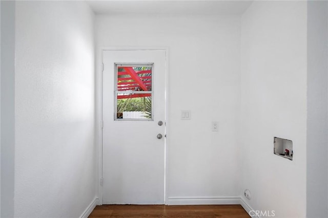 doorway to outside featuring dark wood-type flooring