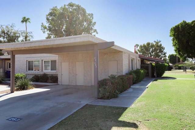 view of property exterior with a lawn and a carport