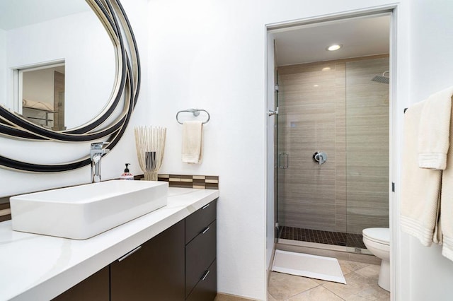 bathroom with walk in shower, vanity, toilet, and tile patterned floors