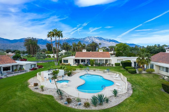 view of swimming pool with a mountain view, a yard, and a patio