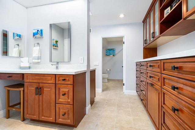 bathroom featuring tile patterned floors, vanity, and toilet