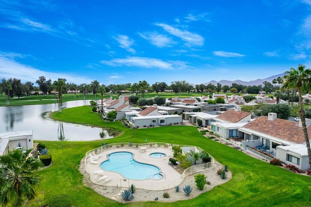 exterior space featuring a water and mountain view and a yard