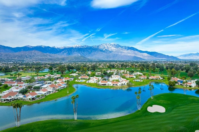 birds eye view of property with a water and mountain view