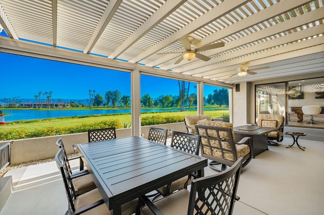 view of patio / terrace with ceiling fan and a water view