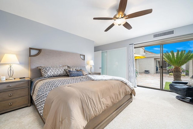 carpeted bedroom featuring ceiling fan and access to exterior