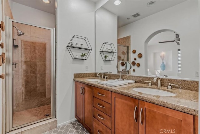 bathroom featuring vanity, a shower with door, tile patterned floors, and ceiling fan